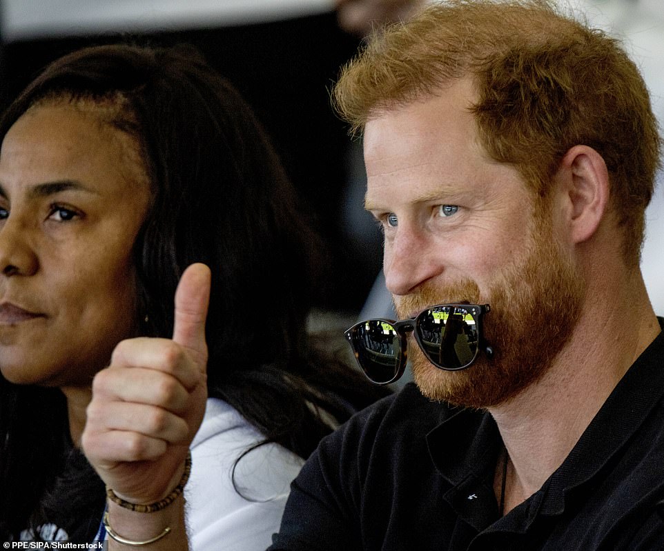 Prince Harry, Duke of Sussex is pictured giving the crowd the thumbs-up as he sits in the crowd on the 2nd day of the Invictus Games