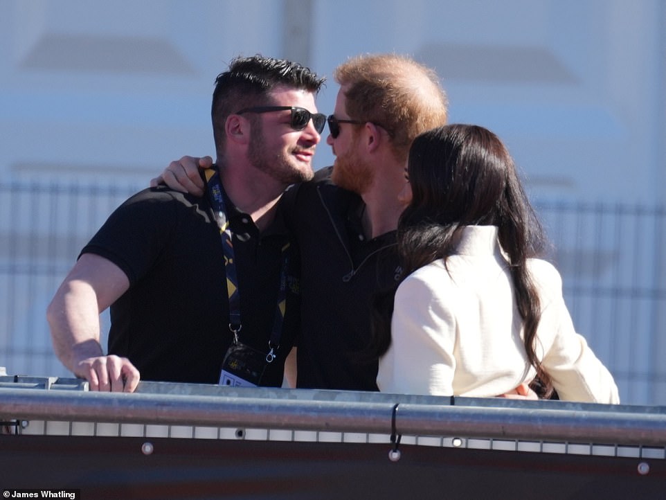 Harry is seen embracing Dave Henson, a former Royal Engineer Search Adviser in the Army who lost both of his legs when he stood on EID in Helmand in 2011