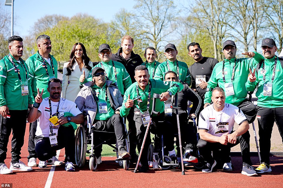 The Duke and Duchess of Sussex pose for a photo with competitors from Iraq at the Invictus Games athletics events in the Athletics Park, at Zuiderpark the Hague, Netherlands, in their first engagement on Sunday