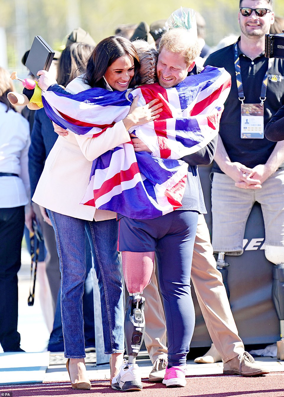 The Duke and Duchess of Sussex hug Team United Kingdom competitor Lisa Johnston at the Invictus Games athletics events in the Athletics Park, at Zuiderpark the Hague, Netherlands