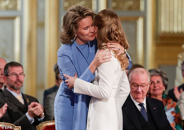 Proud mother: Elisabeth, heir to the Belgium throne, was congratulated by her mother Queen Mathilde after receiving the Order of Leopold during today's ceremony. Elisabeth is now old enough to rule without a regent being appointed