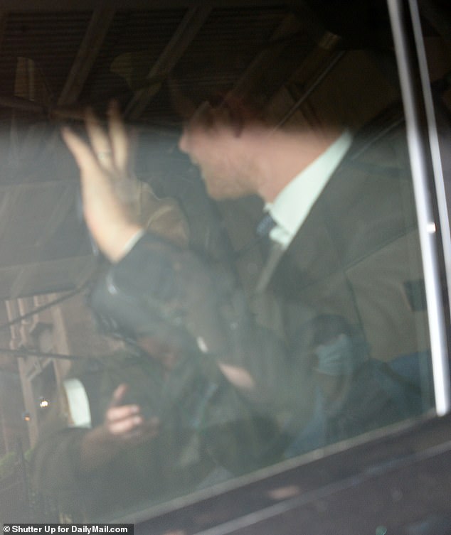 Prince Harry waves as he and his wife leave the ritzy, $1,300-a-night New York City hotel for their Thursday ventures through Manhattan