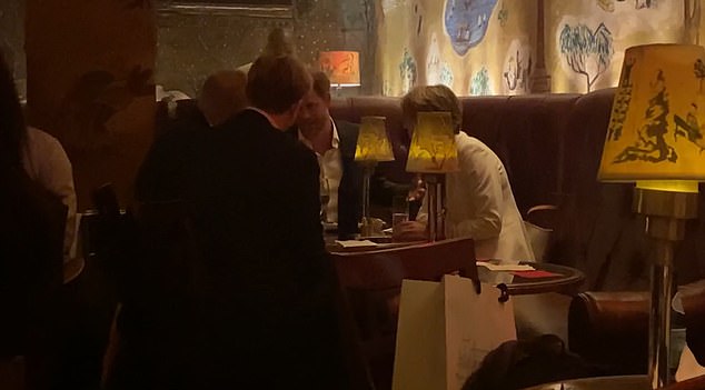 Prince Harry is seen talking to a group of people in the corner of - Bemelmans Bar - upscale New York City hotspot on Manhattan's Upper East Side