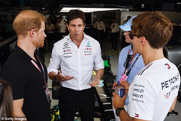 The Duke of Sussex , 39, wore a black polo shirt and a pair of sunglasses as he went behind the scenes to meet the Mercedes team