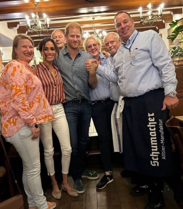 The Duchess of Sussex donned a structured red and white pinstriped shirt and her white frame jeans, plus Manolo Blahnik beige pumps, as she celebrated Prince Harry's birthday at dinner