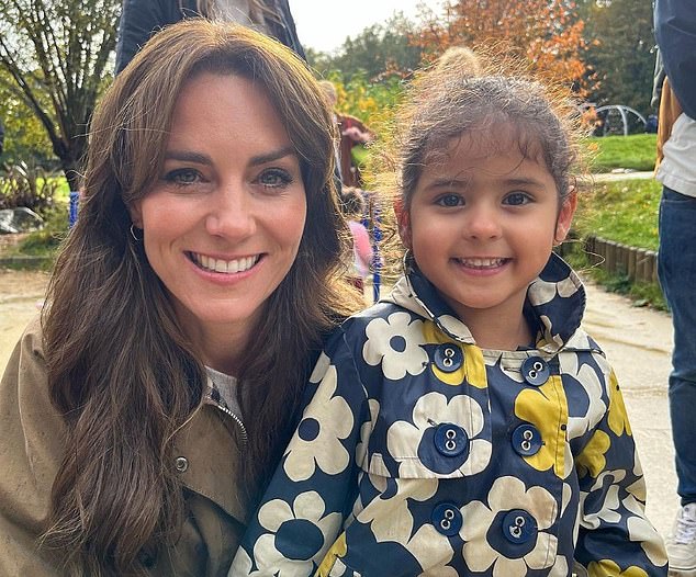 Kate crouched down alongside one young girl as her proud father captured the moment on his mobile phone