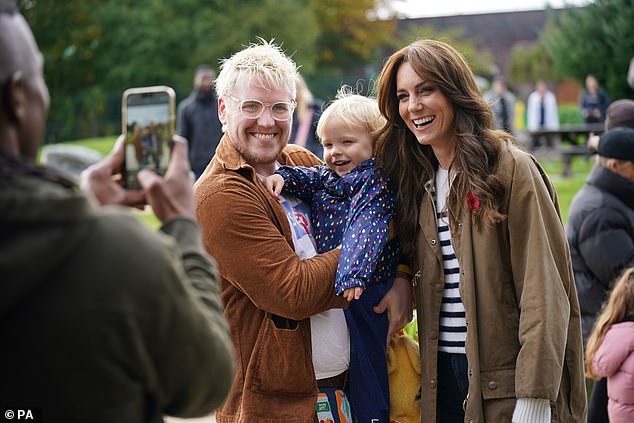 She eagerly posed for photographs with a number of children while walking through Arnos Grove