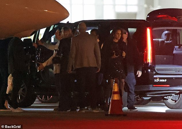 Meghan Markle (right) exits her car after flying to Las Vegas