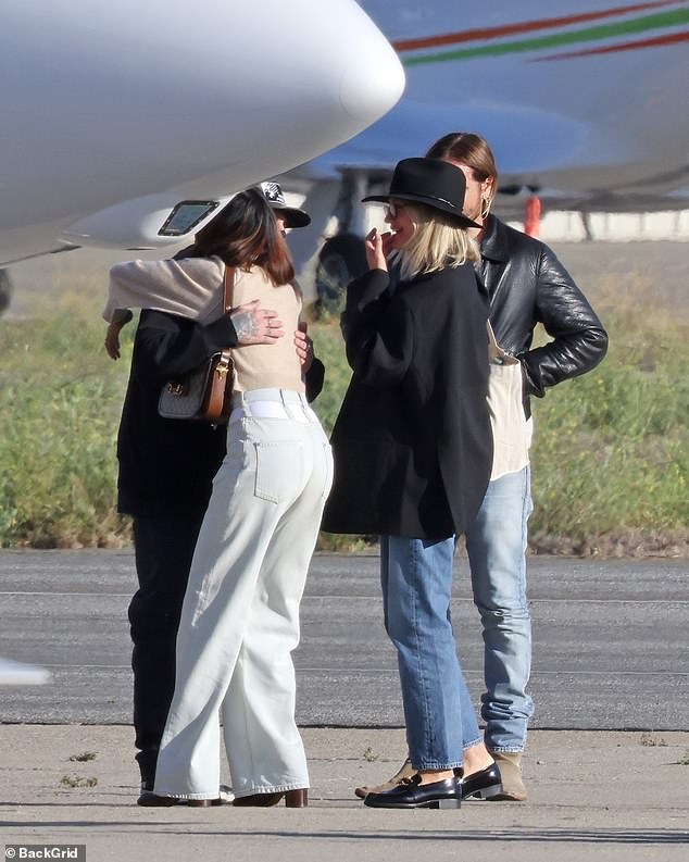 The group enjoyed quick greetings and hugs before boarding