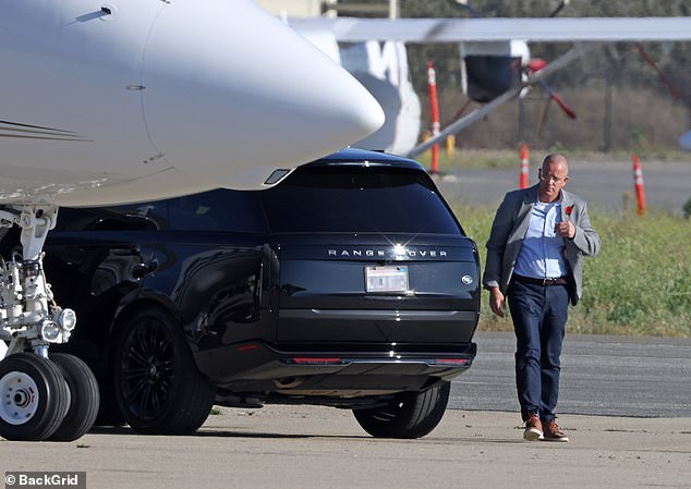 A man believed to be one of the Sussexes bodyguards was seen exiting their car, wearing a poppy - a symbol of remembrance of the First World War