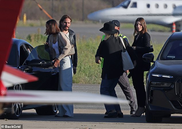 Everyone exited their cars as they arrived at the airport