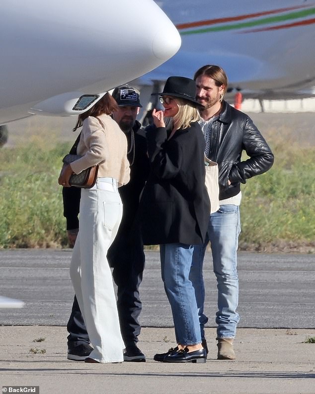 Zoe and Cameron walked alongside each other as they entered the aircraft