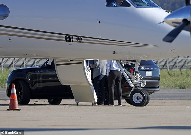 The group boarded the plane in unison