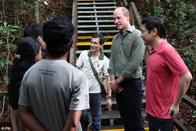 The Prince of Wales speaks to NPark Rangers and NPark Youth Stewards for Nature during a TreeTop Walk at Central Catchment Nature Reserve in Singapore this morning