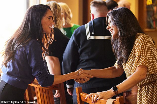 The Duchess of Sussex, wearing a $1,490 Carolina Herrera poppy cardigan, is seen on Wednesday at Camp Pendleton in California