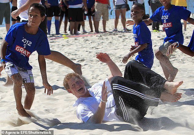 Prince Harry fell to the ground during a game of rugby when attending a Sports Day at Flamengo Beach, Rio de Janeiro, in March 2012