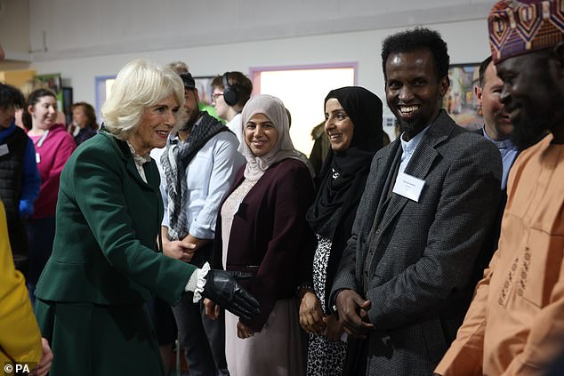 Queen Camilla shakes hands with community leaders in Didcot; the royals also met with supermarket chiefs during the visit