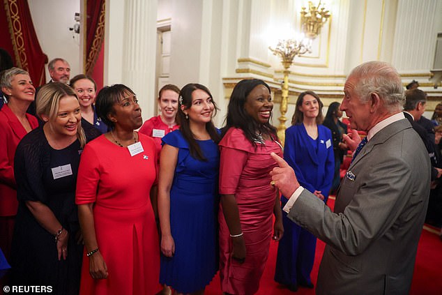 Charles speaks to members of the NHS Choir as they were singing on his birthday