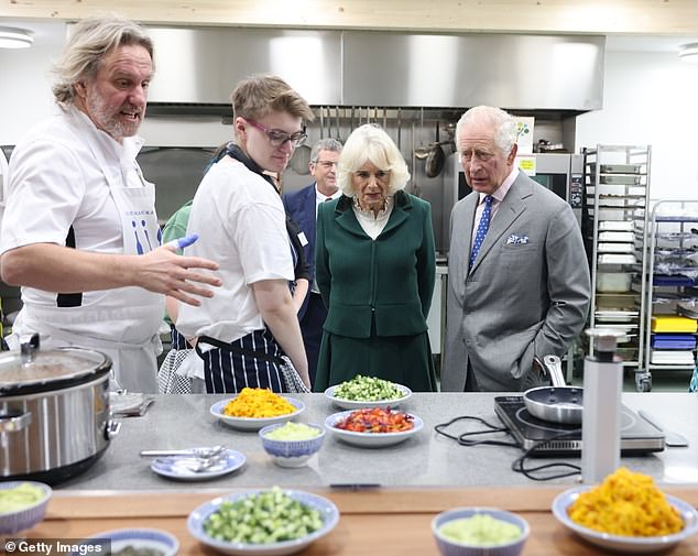 The royal couple visited the kitchen at the food hub, meeting New Zealand chef Alex, far left, and admiring some of the dishes created from surplus food