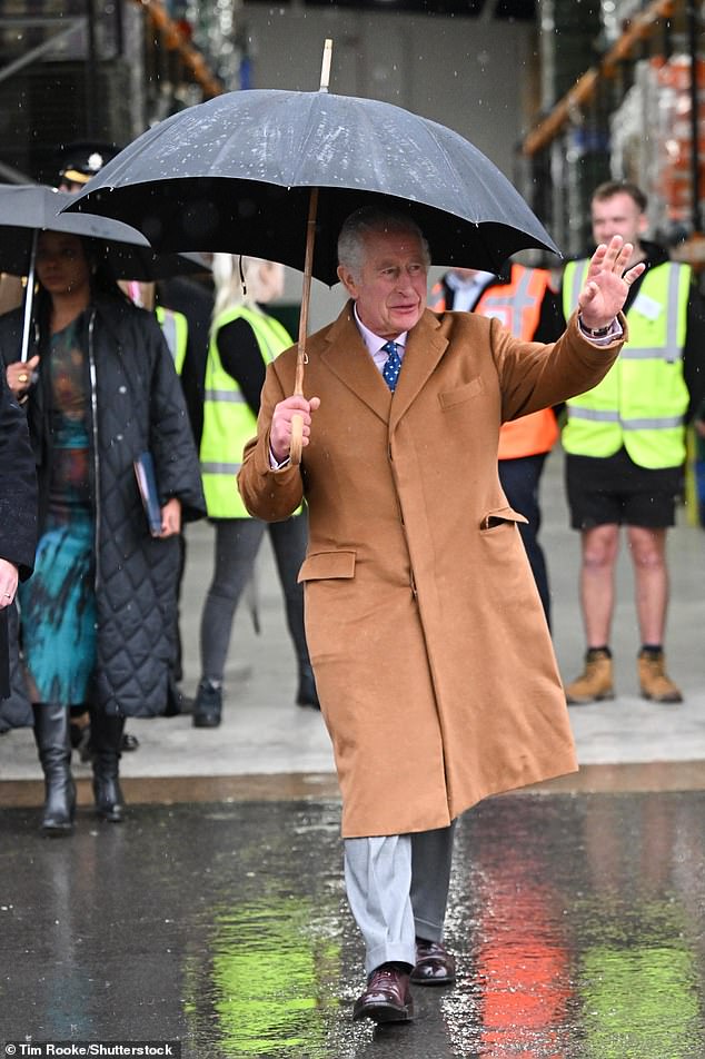 Waving in the rain! The King, who's enjoying a working birthday but will celebrate privately this evening with friends and family, looked in good spirits as he waved to the crowds ahead of launching the initiative in Didcot