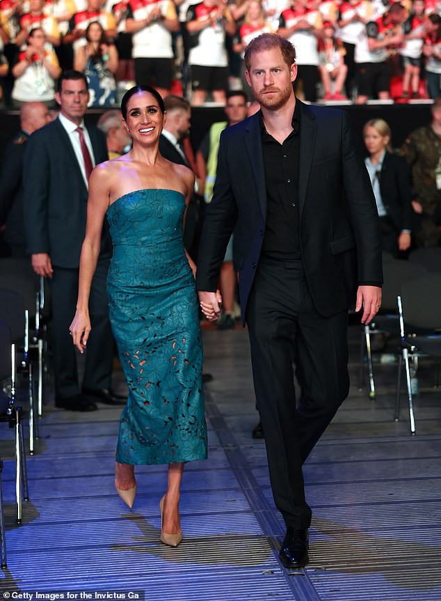 Harry and Meghan pictured attending the closing ceremony of the Invictus Games