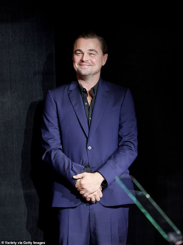 Dapper: The Academy Award winner was clad in a navy blue suit with black button-up shirt at the industry function