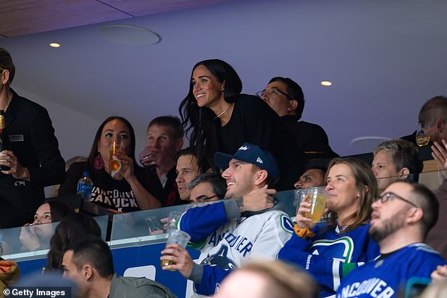 Meghan cmiles as she takes to her seat after an exciting moment in the hockey match