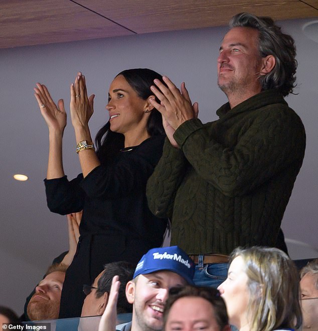 Up in the VIP box, Meghan and close pal Markus were cheering as Harry looked to the heavens to the left