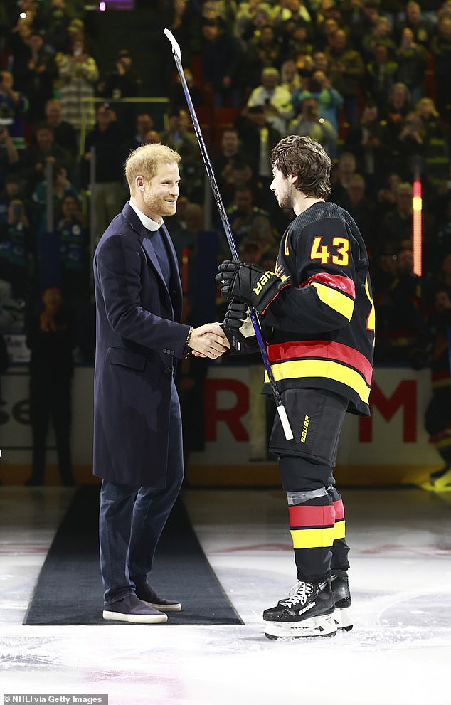 Prince Harry shook hands with Quinn Hughes of the Canucks with a broad smile across his face