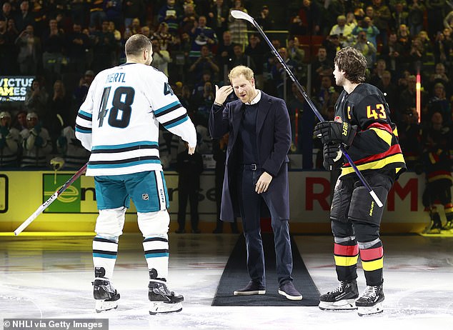 Harry was seen cracking jokes with the players after he walked onto the ice, ahead of the match at the Rogers Arena