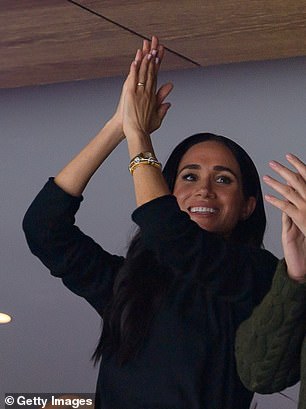 Meghan pictured at a Vancouver Canucks ice hockey game with Prince Harry on 20 November