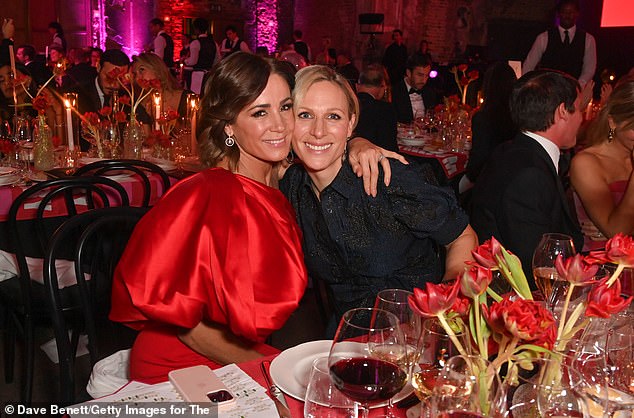 Zara was seated next to close friend Natalie Pinkham who looked equally striking in a one-shoulder red satin gown