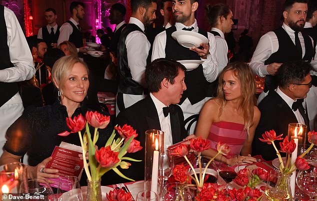 She was also seated with musician James Blunt and actress and model Cressida Bonas