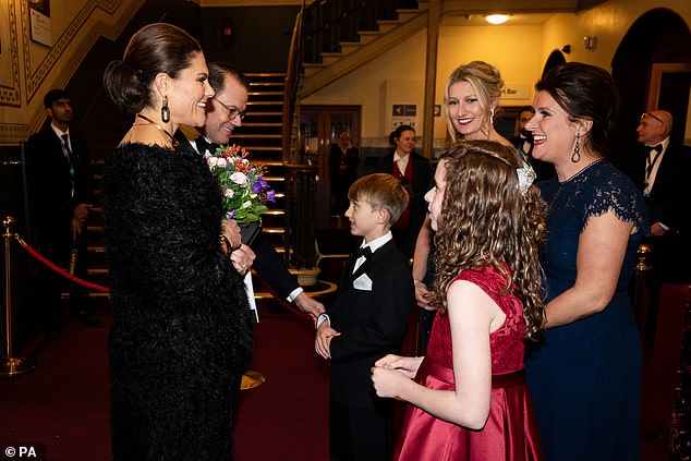 Crown Pricness Victoria of Sweden also gracefully accepted a posy of flowers as she arrived at the performance