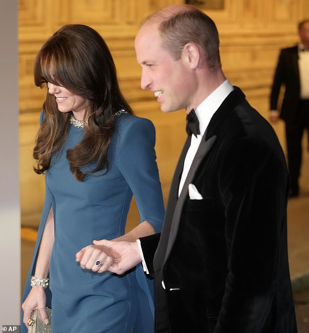 The Prince of Wales took his wife's hand as they walked along the red carpet into the Royal Albert Hall