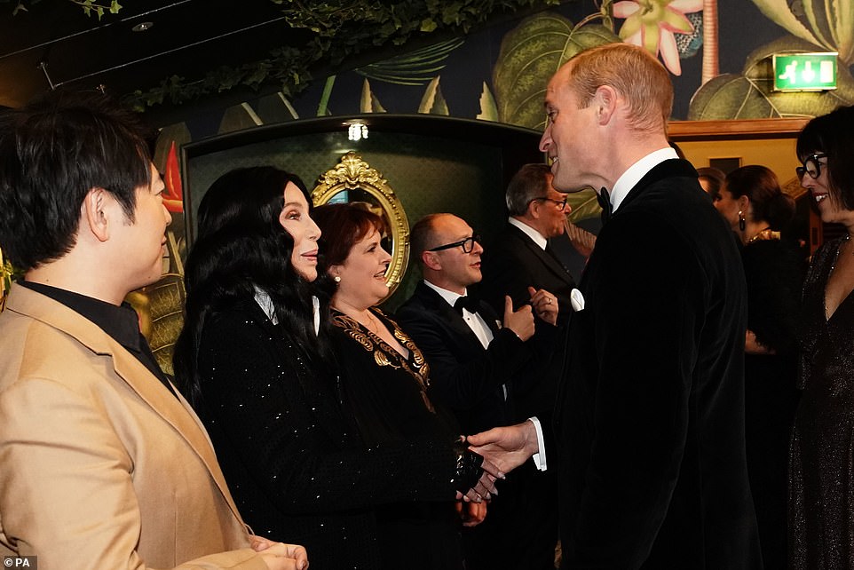 Meanwhile Prince William looked sharp in a black tuxedo, and he acted as the perfect gentleman as he held out his hand for his wife as they took to the red carpet. On arrival they met ITV executives before being introduced to Daphne Selfe, who at 95 is the world¿s oldest supermodel. Excited crowds gathered outside the hall to peer through the windows for the royal arrival. Speaking to Ms Selfe, Prince William said: ¿You¿re modelling at 95, that is incredible,¿ before adding: ¿They don¿t make you travel about too much do they?¿ Pictured: The Prince of Wales talking to a glamorous Cher at the Royal Albert Hall last night.