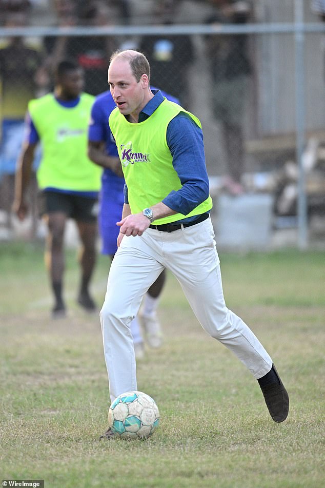 Prince Harry and Prince William are known to get stuck in with a merry game of football at the annual Sandringham Christmas Eve football match (Pictured: Prince William plays football on March 22, 2022 in Kingston, Jamaica)