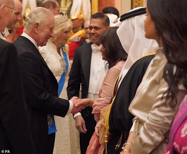 Charles appeared cheerful as he greeted guests with a handshake at the glittering occasion