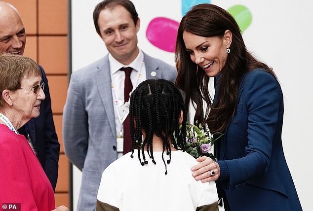 The Princess greeted a young boy and tapped him on the shoulder