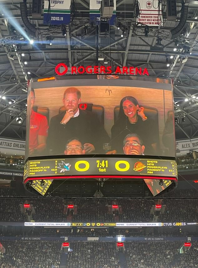 The Duke and Duchess on the jumbotron giant screen - but they did not kiss for the crowd