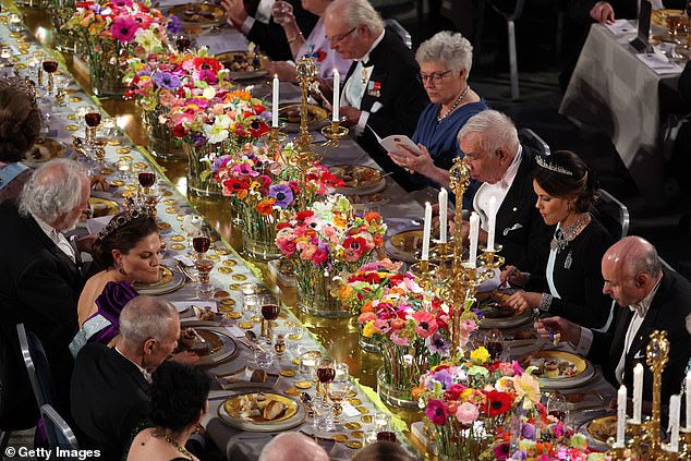 An ornate selection of food was presented at the tables - which were decorated with vases of colourful flower bouquets