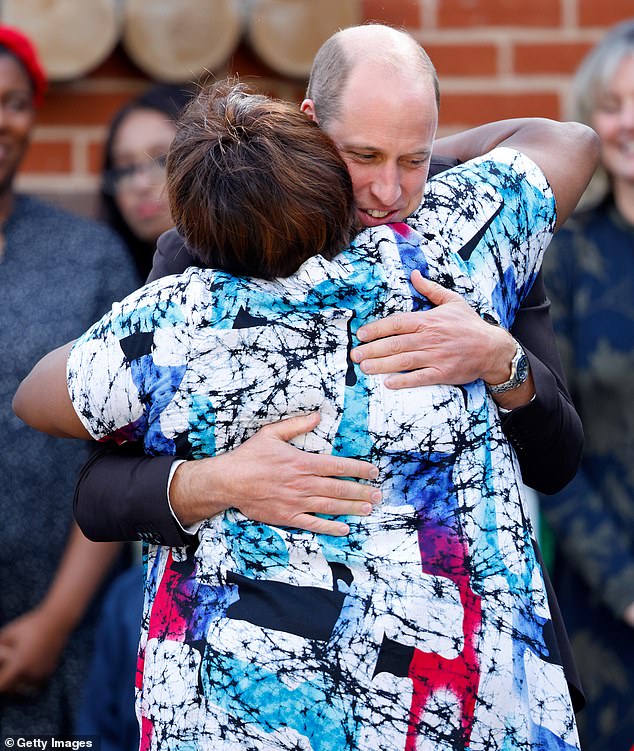 Prince William, Prince of Wales embraces Professor Uzo Iwobi, Founder of Race Council Cymru in Cardiff this year