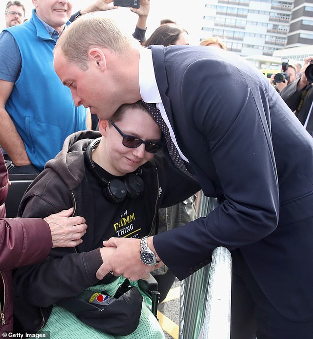 Prince William, hugs Katie Daley during a visit to Aintree University Hospital on September 2017 in Liverpool