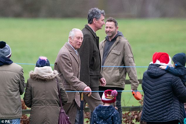 The king was wearing his favourite tweed coat, thought to be around 40 years old and from Savile Row, over a slate grey suit, with brown suede shoes