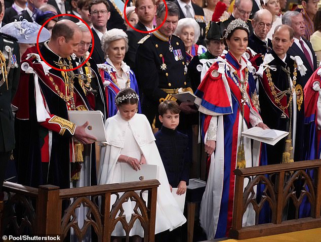 Prince Harry wore an awkward smile as he was forced to watch the Coronation of his father King Charles III from his relegated seat in the third row - while his brother Prince William took centre stage