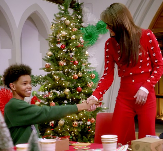 'Do you mind if I join you?' Dressed in a very festive red - including a favourite Miu Miu jumper - the Princess of Wales leaves teenage footballer Rico looking shocked as she takes a seat at the festive tea party table