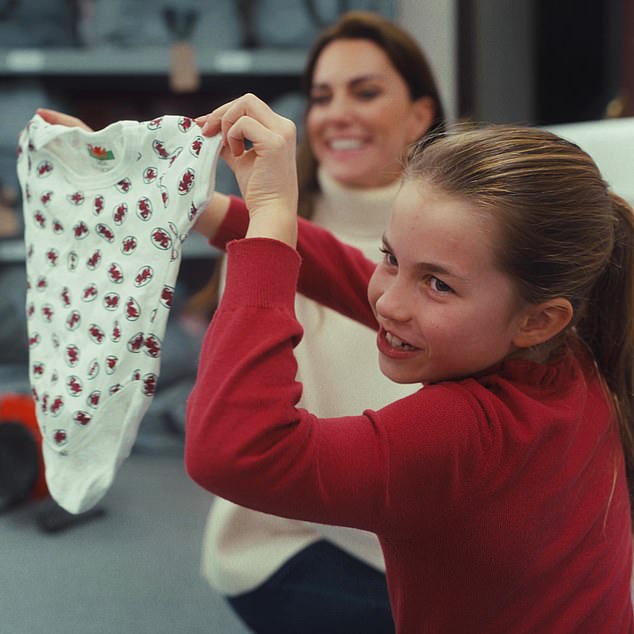 The Princess of Wales and her children including Princess Charlotte, pictured here with a tiny vest, paid a visit to  their local baby bank. The visit featured in a slick video from Kensington Palace