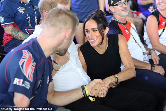 Mark (left) even shock hands with the Duchess of Sussex, Meghan Markle as they cheered on competitors at the contest in Duesseldorf, Germany, in September