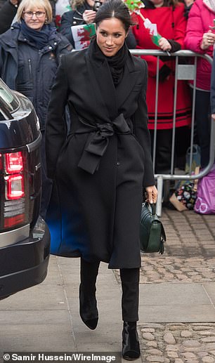 Meghan Markle wears a black wrap coat for a visit to Cardiff Castle in January 2018