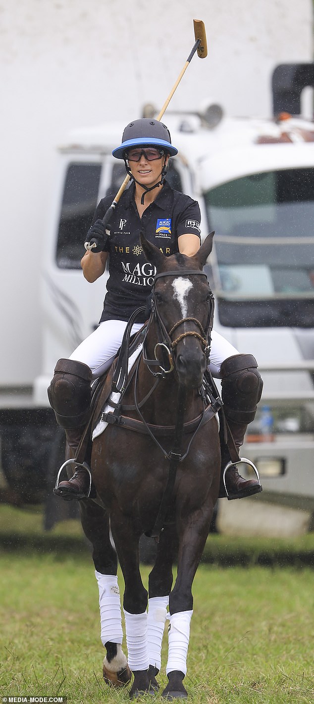 She teamed her white Jodhpurs with brown riding boots and a black polo shirt during today's activities